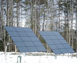 New Hampshire winter scene with solar PVs and an old stone wall. Photos by Kim Frase.